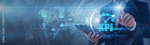 Operations lead pointing KPI performance metrics. Manager using tab analyzing key performance indicators and target attainment on hologram screen. Business measurement and KPI goals.