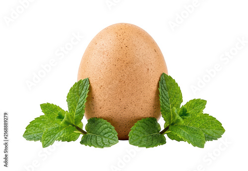 Foto Fresh Brown Egg Flanked By Green Mint Leaves Isolated