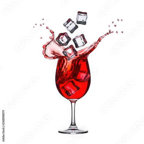 Red cocktail splash with ice cubes in glass isolated on white background