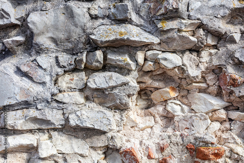 Rugged gray stone wall texture with rock blocks