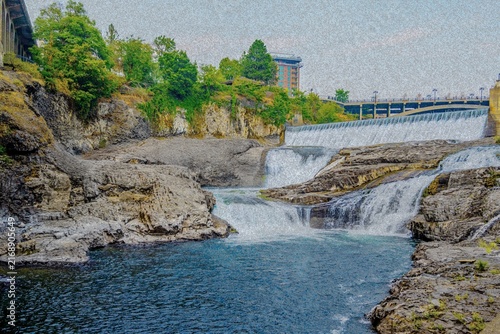 Spokane Falls waterfall cascading down dramatic basalt rock formations in Riverfront Park Spokane Washington