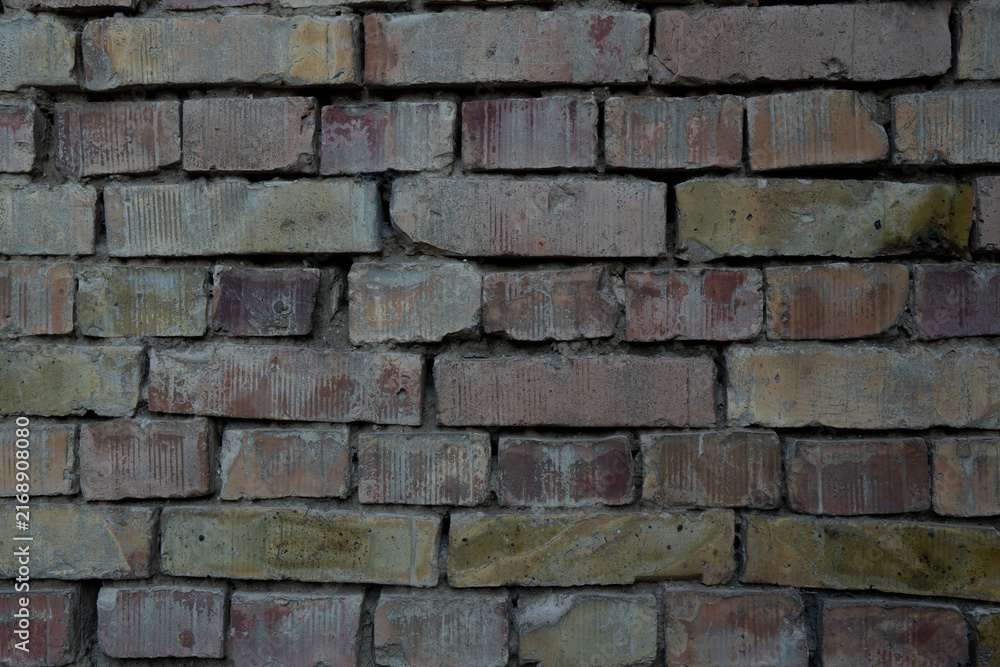 Obraz premium Weathered brick wall with rough aged texture