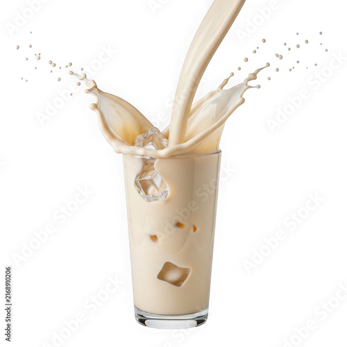 Iced coffee splash in a glass with milk and ice cubes isolated on white background