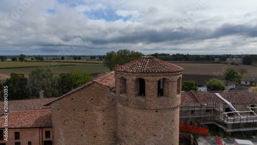 фотографія Calendasco Castle showcasing its brick tower and historic architecture, blending