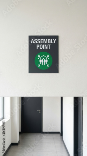 Assembly Point Sign Mounted Above Hallway With Doors