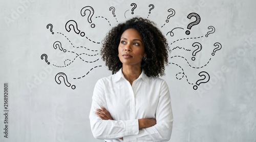 Pensive African American businesswoman contemplating numerous questions.