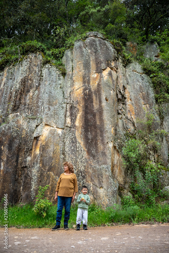 Grandmother and grandson posing together against a large rock wall in Mineral del Chico, Hidalgo, Mexico.