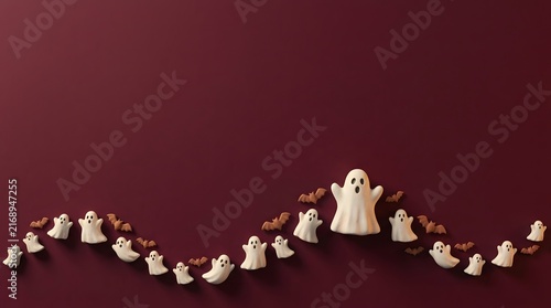 Fototapeta kuchenna A wavy line of small white ghost figures and tiny brown bats on a red background.