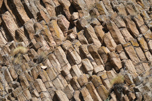 Columnar jointing of volcanic rocks. Volcanic forms background.
