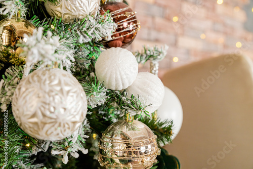 Decorating Christmas tree on bright background, White Christmas ball toy.Merry Christmas, Scandinavian style. Christmas decor. ornaments and garland lights, Christmas holidays background.