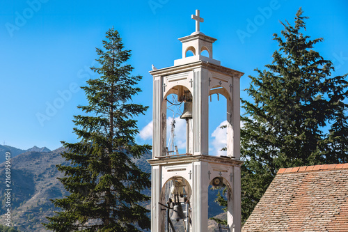 White bell tower of church of the archangel michael rising in platanistasa, Cyprus