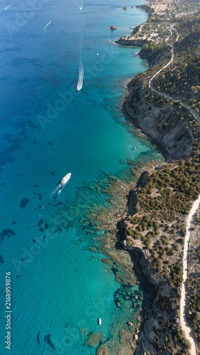 Akamas coastline, aerial view with boats sailing on turquoise sea in Cyprus