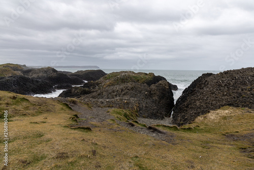 Natural coastal beauty at Ballintoy Point in Northern Ireland with cloudy sky