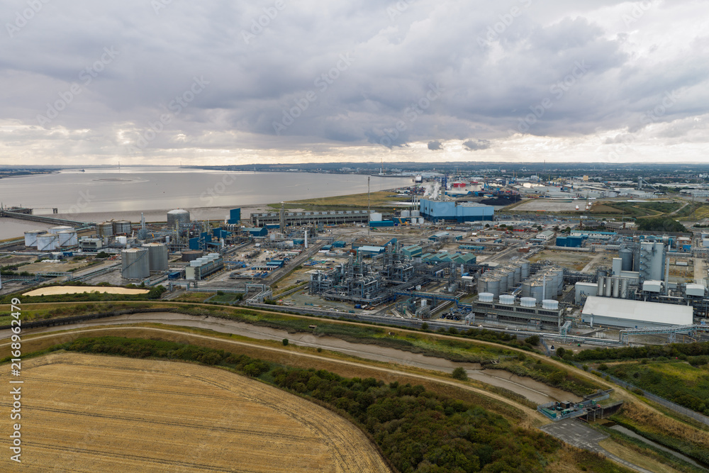 Fototapeta premium Chemical Plant Production Facility Operating Near the Humber Estuary Under a Cloudy Afternoon Sky