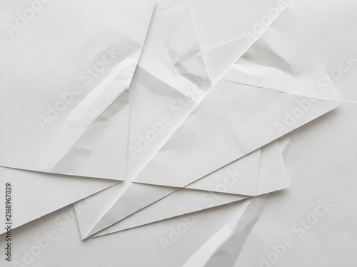 Abstract background texture created with layers of white paper sheets featuring sharp geometric folds and shadows