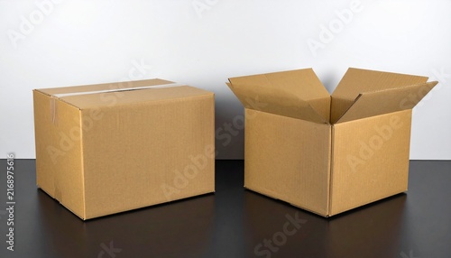 Open and sealed brown cardboard delivery boxes placed side by side isolated on a clean white background