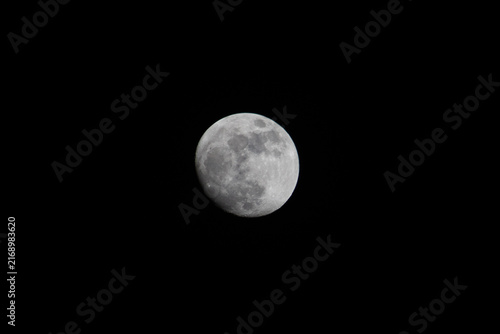 Konstfotografi almost full moon in a black background