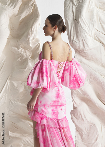 Quadro su tela Rear back view of elegant woman wearing luxury pink floral watercolor floral org