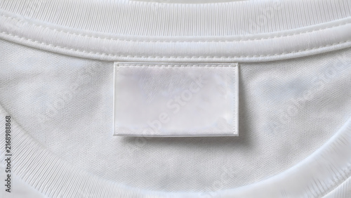 Blank white clothing label on cotton t-shirt neck. Close-up of textile tag, apparel branding concept, mockup template.