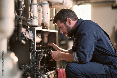 HVAC technician servicing residential furnace