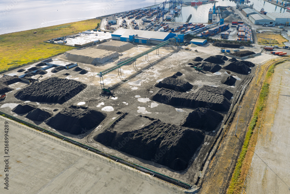 Fototapeta premium Aerial View of Coal Piles and Storage Facility at the Port of Cork During a Bright Afternoon Day