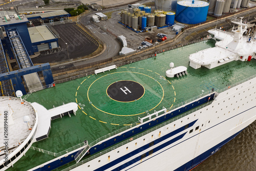 Quadro su tela Helipad on the Deck of a Large Ferry Ship Docked at an Industrial Harbor During