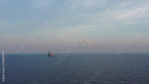 Jack up drilling rig in the middle of the ocean on sunny day
