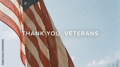 An American flag waving proudly against a blue sky with clouds, accompanied by a message of gratitude honoring the service, dedication, and sacrifices of military veterans on a national holiday