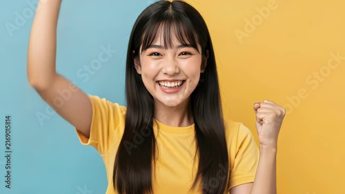 Joyful Celebration: A young woman beams with happiness, her arms raised in a gesture of triumph, celebrating a moment of pure elation.