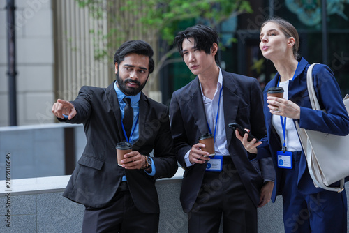 Fotografía A multiethnic business team of three colleagues laugh together during a coffee b