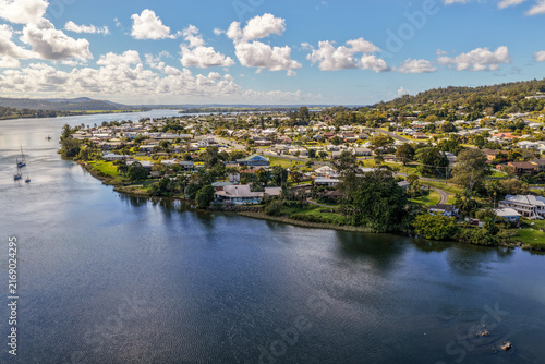 Aerial view of the town of Maclean positioned along the banks of the Clarence River, showing the township, broad waterway and surrounding green rural landscape in the Northern Rivers region of NSW