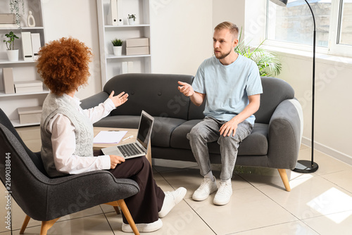 Mental health therapy session, young man talking to female psychologist or co...