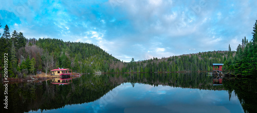 Canvas Print Wooden Cabin Reflected on Mirror-Like Lake du Trou, Quebec