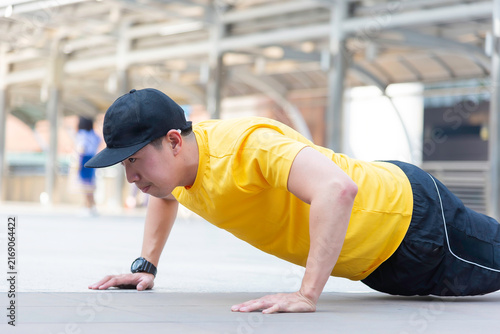 Asian man exercise in the gym. Healthy and Lifestyle Concept.