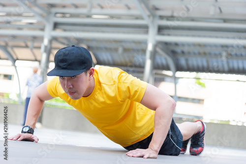 Asian man exercise in the gym. Healthy and Lifestyle Concept.