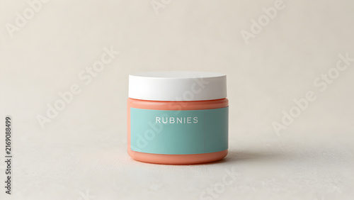 Cosmetic jar with light blue label on a neutral surface