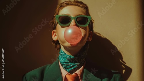 Low-angle portrait of stylish woman with bubblegum, retro editorial video mood.