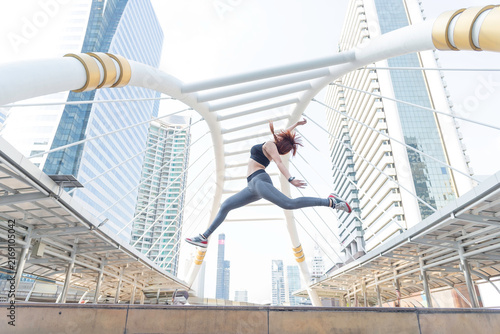Asian young beautiful slim woman wearing sport cloths fly or jump into the sky, diet weight loss and moving for high jumping concept
