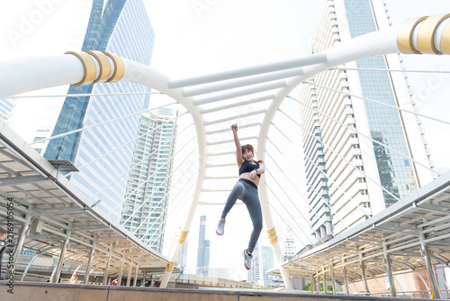 Asian young beautiful slim woman wearing sport cloths fly or jump into the sky, diet weight loss and moving for high jumping concept