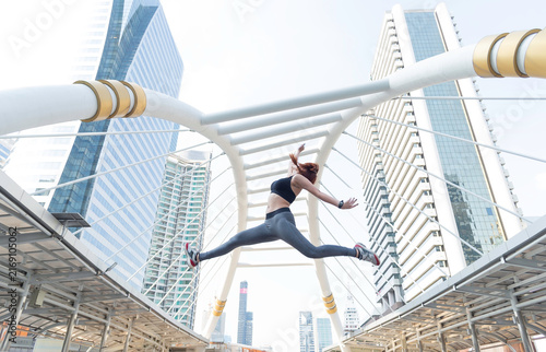 Asian young beautiful slim woman wearing sport cloths fly or jump into the sky, diet weight loss and moving for high jumping concept
