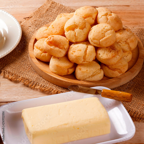 Minas Gerais cuisine featuring homemade cheese bread, fresh Minas cheese, and butter on a rustic wooden table
