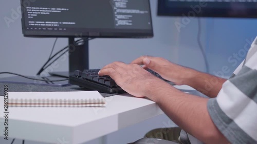 Software engineer wearing casual clothing typing on keyboard desktop computer information AI, management cybersecurity or coding software development. Programmer adult working artificial intelligence