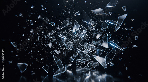 sharp shards of broken glass exploding violently through the air, hundreds of crystal fragments suspended in dynamic motion