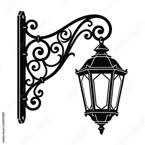 Vintage black metal street lantern mounted on an ornate wall bracket