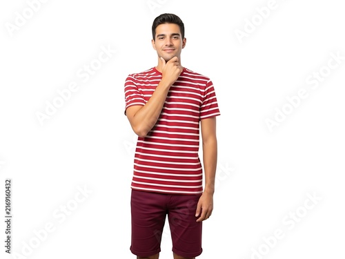 A contemplative young man in a striped shirt posing against white background
