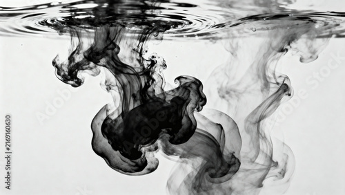 Black ink swirling in clear water, abstract liquid smoke effect