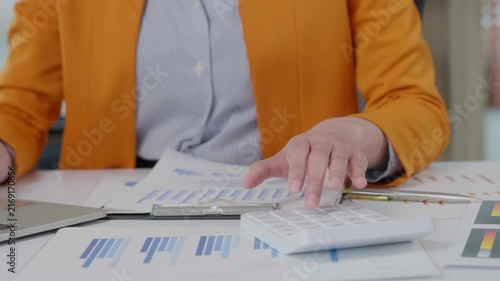 Businesswoman calculating financial data using a calculator