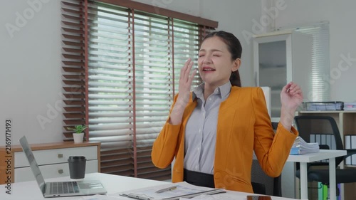 Tired businesswoman yawning and stretching with back pain