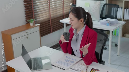 Young asian businesswoman video conferencing on laptop