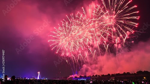 Spectacular Fireworks Display Over Silhouetted Crowd at Night